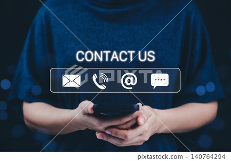Contact Us and customer support concept. A person holding smartphone with icons representing contact options like email, phone, chat, and online support. customer service, communication, assistance, Contact Us and customer support concept. A person holding smartphone with icons representing contact options like email, phone, chat, and online support. customer service, communication, assistance, 140764294