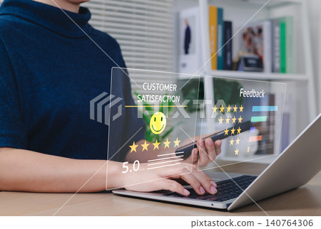 Customer Satisfaction and Feedback Rating Concept. Person using laptop with virtual interface showing customer satisfaction scores, 5-star reviews, and feedback metrics for service evaluation. Customer Satisfaction and Feedback Rating Concept. Person using laptop with virtual interface showing customer satisfaction scores, 5-star reviews, and feedback metrics for service evaluation. 140764306