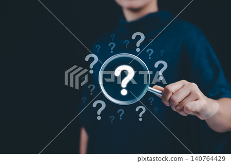 Question mark and root cause analysis concept. A hand holding a magnifying glass over large question marks surrounded by smaller ones symbolizes cause analysis and problem-solving. solution, analyze, 140764429