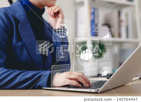 Digital Marketing Strategy and Target Audience Concept. Businessperson working on laptop with digital icons representing email, analytics, audience targeting, SEO, video, campaign, and online ads. Digital Marketing Strategy and Target Audience Concept. Businessperson working on laptop with digital icons representing email, analytics, audience targeting, SEO, video, campaign, and online ads. 140764447