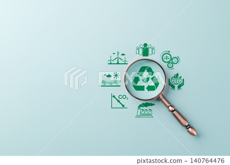 Renewable Energy and Sustainability Planning Concept. Magnifying glass focuses on green recycle icon represent renewable energy, low emissions, environmental protection, and sustainable development. Renewable Energy and Sustainability Planning Concept. Magnifying glass focuses on green recycle icon represent renewable energy, low emissions, environmental protection, and sustainable development. 140764476