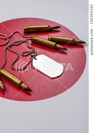 A dog tag on the Japanese flag, serving as a conceptual backdrop representing defense A dog tag on the Japanese flag, serving as a conceptual backdrop representing defense 140764583