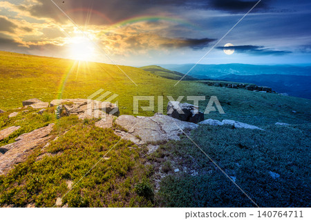 carpathian mountain landscape on summer solstice. amazing background for outdoor adventure at twilight. transcarpathia green hill with rocks. day and night time change metaphor carpathian mountain landscape on summer solstice. amazing background for outdoor adventure at twilight. transcarpathia green hill with rocks. day and night time change metaphor 140764711