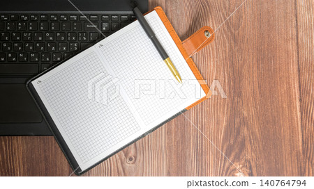 notebook with pen on laptop keyboard top view notebook with pen on laptop keyboard top view 140764794