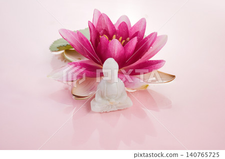 White buddha statue meditating on pink lotus flower White buddha statue meditating on pink lotus flower 140765725