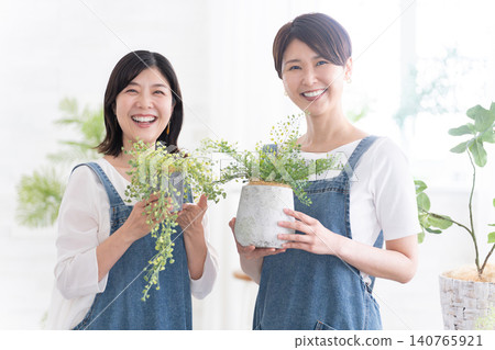 Female shop assistant at a gardening shop Female shop assistant at a gardening shop 140765921