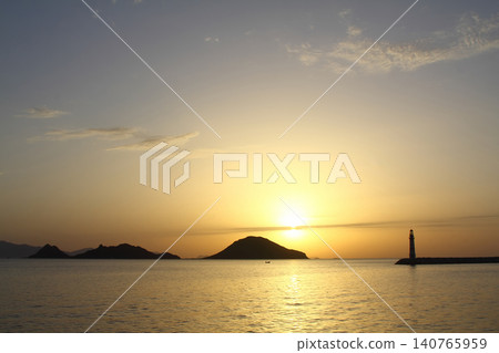 Seascape at sunshine. Lighthouse and sailings on the coast. Seaside town of Turgutreis and spectacular sunshine Seascape at sunshine. Lighthouse and sailings on the coast. Seaside town of Turgutreis and spectacular sunshine 140765959