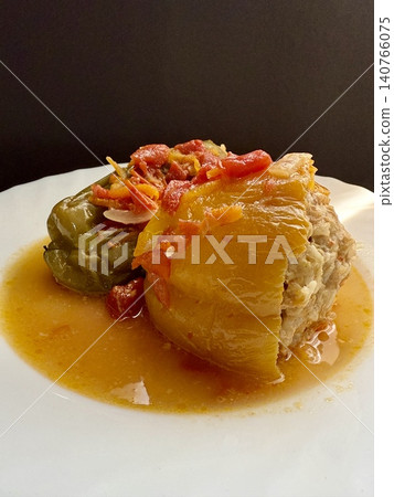 Bell peppers stuffed with meat and rice, stewed in tomato sauce. Delicious and healthy home cooking. 140766075