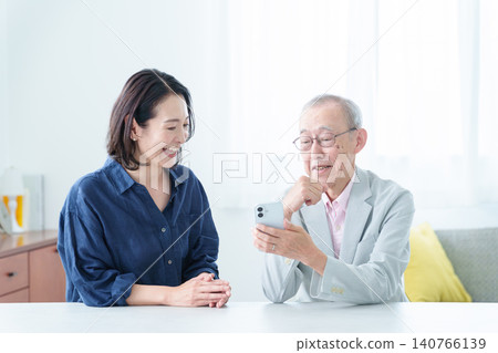 An elderly man learning about smartphones An elderly man learning about smartphones 140766139