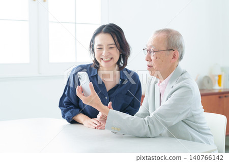 An elderly man learning about smartphones 140766142