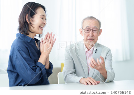 An elderly man learning about smartphones An elderly man learning about smartphones 140766148