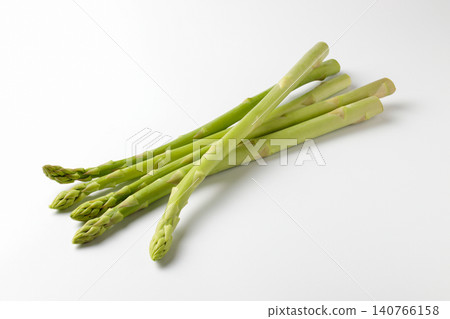 Five asparagus spears lined up against a white background Five asparagus spears lined up against a white background 140766158