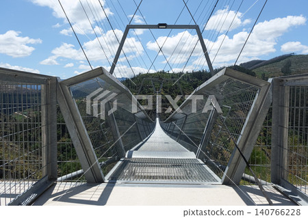 Arouca 516 suspension bridge crossing a dramatic valley in Portugal, showcasing modern engineering, adventure tourism, geometric design, scenic landscapes, and outdoor exploration Arouca 516 suspension bridge crossing a dramatic valley in Portugal, showcasing modern engineering, adventure tourism, geometric design, scenic landscapes, and outdoor exploration 140766228