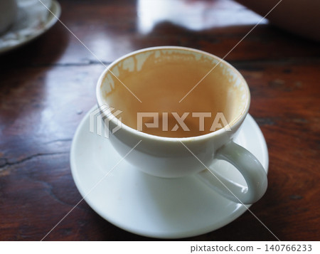 Cup, coffee, saucer, table, empty cup with residue on wooden cafe table Cup, coffee, saucer, table, empty cup with residue on wooden cafe table 140766233