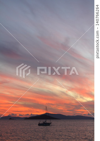 Alone sailboat at sunset. Atmospheric seascape with reflection 140766264