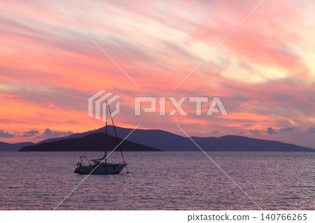 Alone sailboat at sunset. Atmospheric seascape with reflection 140766265