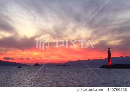 Seascape at sunshine. Lighthouse and sailings on the coast. Seaside town of Turgutreis and spectacular sunshine Seascape at sunshine. Lighthouse and sailings on the coast. Seaside town of Turgutreis and spectacular sunshine 140766268