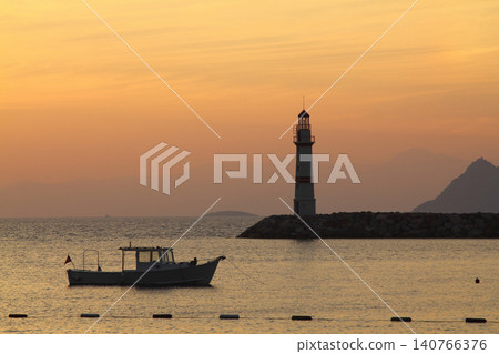 Seascape at sunshine. Lighthouse and sailings on the coast. Seaside town of Turgutreis 140766376