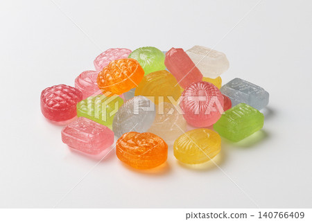 Colorful drop candies lined up against a white background 140766409