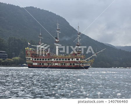 The Hakone pirate ship sailing on Lake Ashi and the sparkling scenery of the lake's surface. The Hakone pirate ship sailing on Lake Ashi and the sparkling scenery of the lake's surface. 140766460