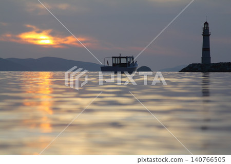 Seascape at sunshine. Lighthouse and sailings on the coast. Seaside town of Turgutreis and spectacular sunshine Seascape at sunshine. Lighthouse and sailings on the coast. Seaside town of Turgutreis and spectacular sunshine 140766505