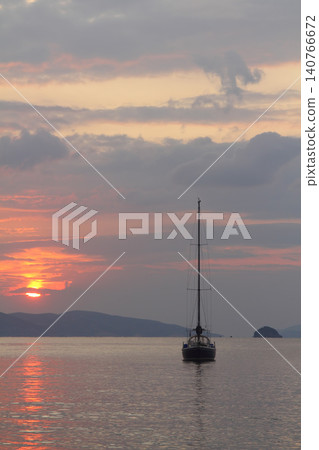 Alone sailboat at sunset. Atmospheric seascape with reflection 140766672