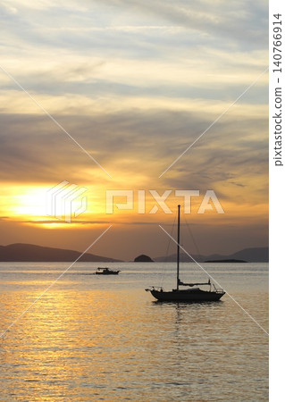 Alone sailboat at sunset. Atmospheric seascape with reflection Alone sailboat at sunset. Atmospheric seascape with reflection 140766914