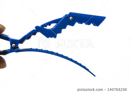 It is a hair clip from a hair salon placed on a white background. It is a hair clip from a hair salon placed on a white background. 140768298
