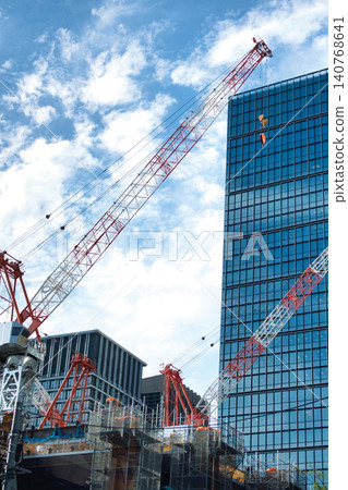 High-rise building under construction and large cranes High-rise building under construction and large cranes 140768641