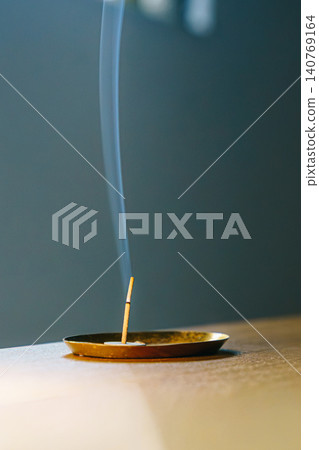 The relaxing image of incense and rising smoke. The relaxing image of incense and rising smoke. 140769164