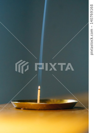 The relaxing image of incense and rising smoke. 140769168