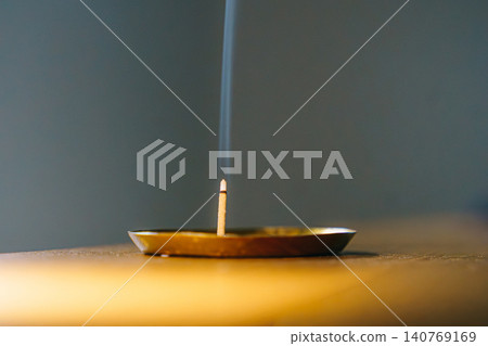 The relaxing image of incense and rising smoke. The relaxing image of incense and rising smoke. 140769169