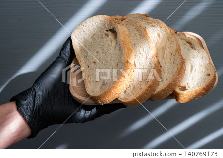 Someone hand holding pieces of sourdough bread in hand. Someone hand holding pieces of sourdough bread in hand. 140769173