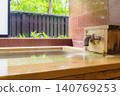 A family bath with a cypress wood tub and still life photographs of the hot spring. 140769253