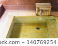 A family bath with a cypress wood tub and still life photographs of the hot spring. 140769254