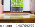 A family bath with a cypress wood tub and still life photographs of the hot spring. 140769255