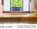 A family bath with a cypress wood tub and still life photographs of the hot spring. 140769256