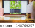 A family bath with a cypress wood tub and still life photographs of the hot spring. 140769257