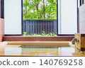A family bath with a cypress wood tub and still life photographs of the hot spring. 140769258