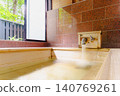 A family bath with a cypress wood tub and still life photographs of the hot spring. 140769261