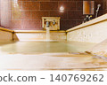 A family bath with a cypress wood tub and still life photographs of the hot spring. 140769262