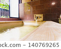 A family bath with a cypress wood tub and still life photographs of the hot spring. 140769265