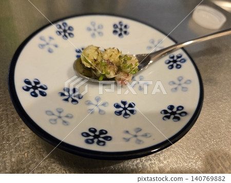 Sweet and sour pickled wild onion bulbils (yam bulbils) scooped with a spoon and placed on a small plate. Sweet and sour pickled wild onion bulbils (yam bulbils) scooped with a spoon and placed on a small plate. 140769882