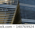 The exterior of a modern glass building 140769924
