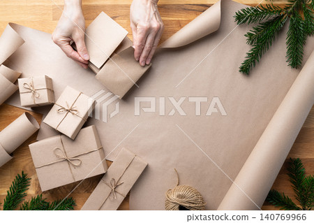 Woman Folding Gift Wrap Christmas Packaging Woman Folding Gift Wrap Christmas Packaging 140769966