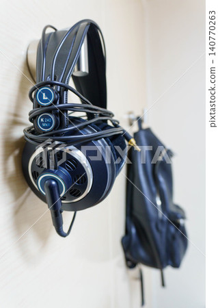 Headphones and bag hanging on the wall Headphones and bag hanging on the wall 140770263