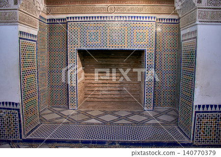 An antique fireplace decorated with zellij tile mosaics shines in Marrakech's Bahia Palace 140770379