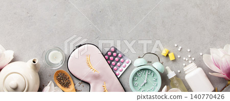 Sleep Wellness Setup with Mask, Pills and Alarm Clock on Soft Background Sleep Wellness Setup with Mask, Pills and Alarm Clock on Soft Background 140770426