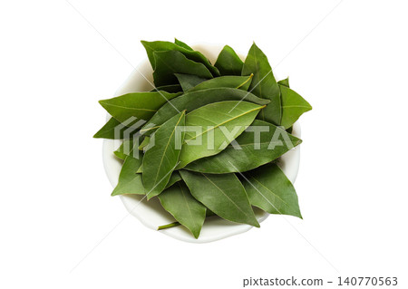Fresh bay leaves are neatly placed in a bowl for culinary preparation, PNG 140770563