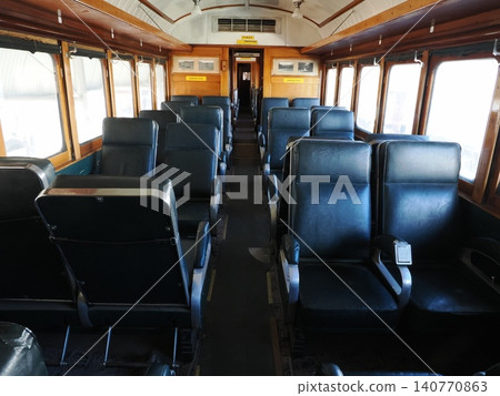 A passenger car seat at the Sulfide Street Railroad History Museum—a quiet corner of the car with striking blue tones. 140770863